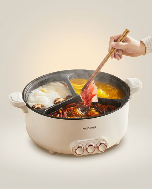 Multifunction Electric Hot Pot and Cooker on a warm ivory studio backdrop